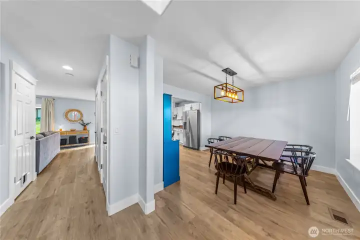 Entry has coat closet and under-the-stairs storage, and is open to the dining room.