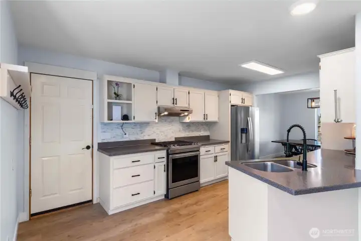 Garage leads directly into the kitchen with a coat rack in the drop zone.