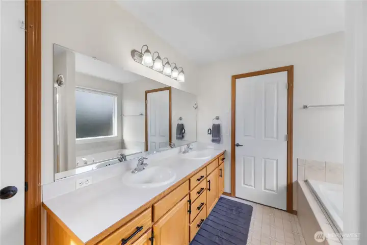 Double vanity in the primary bathroom means there's room to spare.