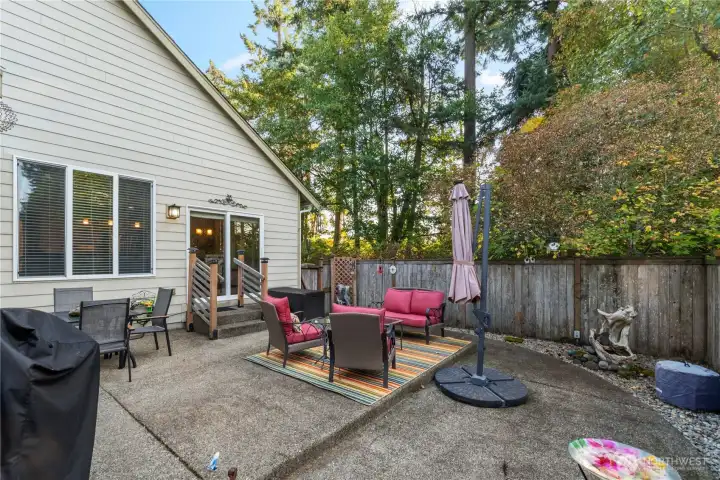 The expanded patio offers lots of space for dining and relaxing next to the serenity of the green space