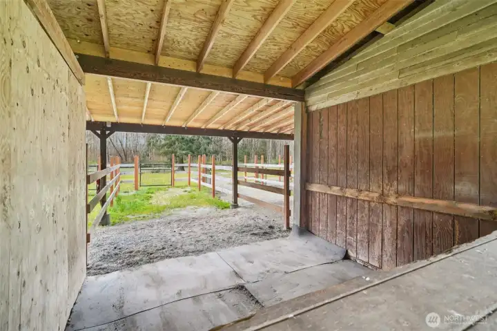 Covered aisle connecting barn and paddock areas for practical daily use
