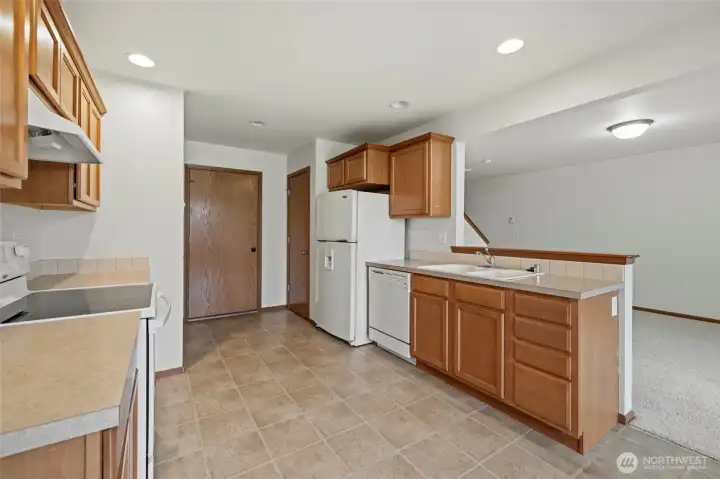 Pantry, half bathroom and garage off the kitchen