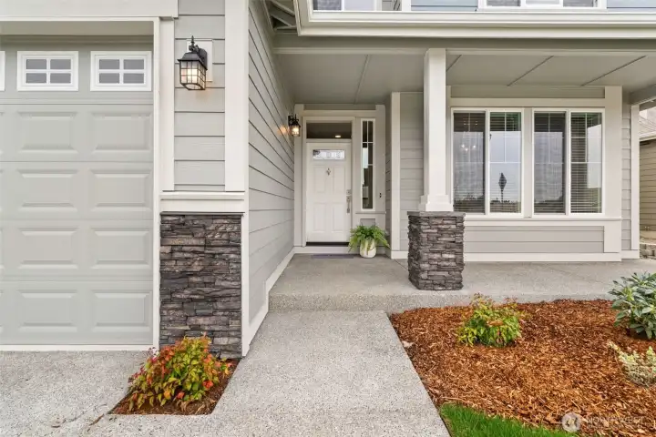 Entry covered porch with stone accents for a strong curb appeal with modern Northwest styling.