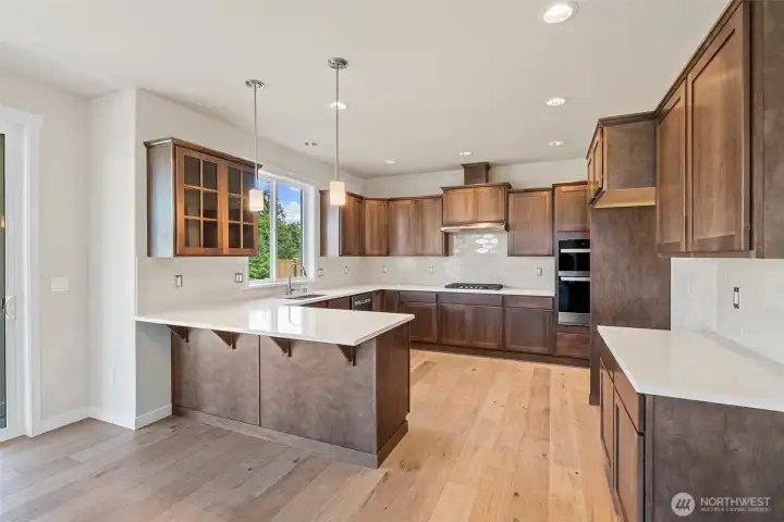 Kitchen- Solid surface Quartz counters with large single-level peninsula