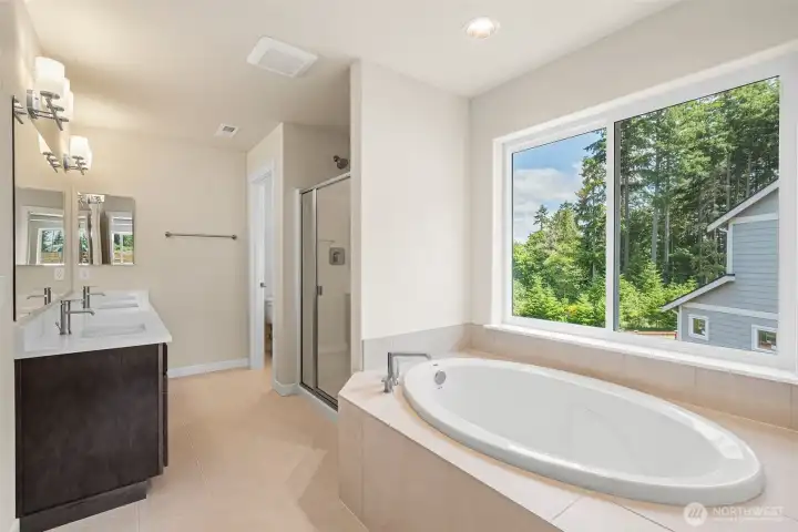 Primary bathroom- 5 piece includes soaking tub with tile surround and standing shower with private water room.