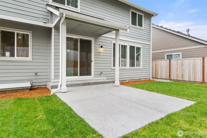 Clean concrete patio, creating an inviting space for additional outdoor living.