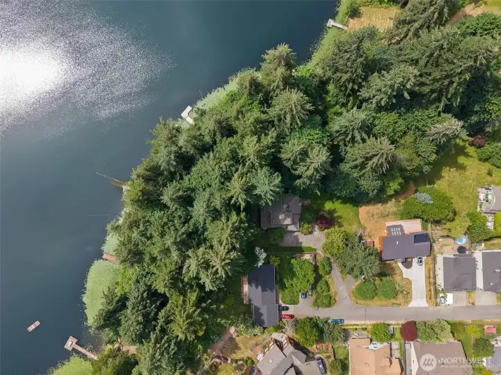 Aerial view of the home with proximity to dock and lake