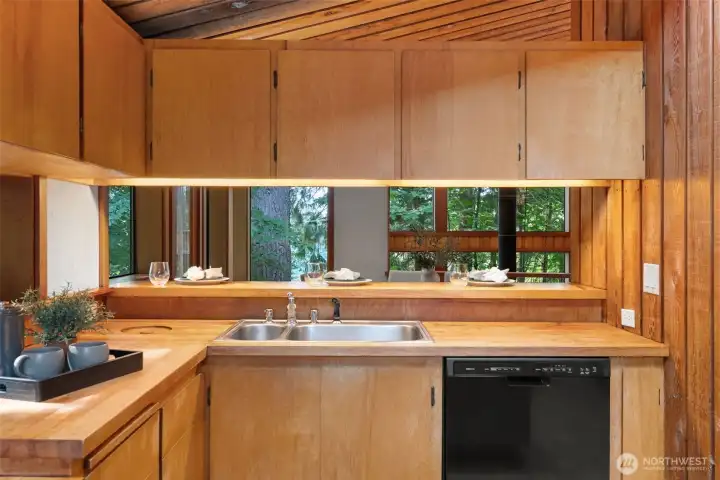 Open to eating bar with custom garbage cabinet in corner with immediate retrieval from exterior