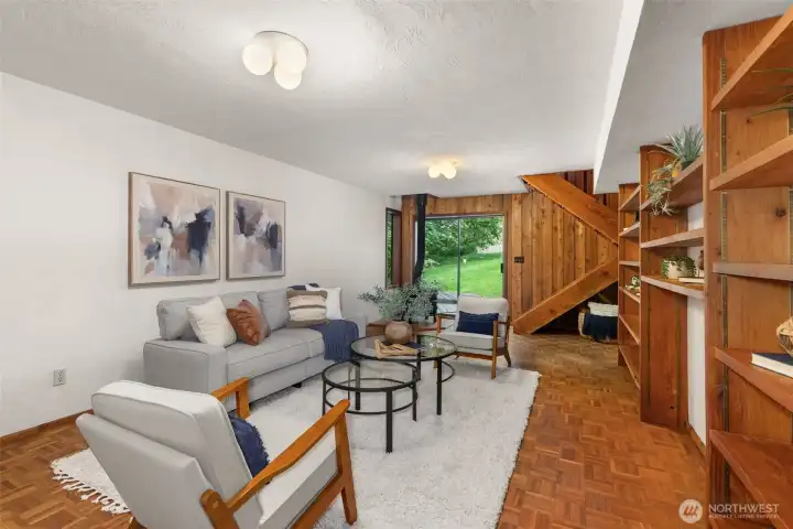 Ballroom or family room with slider to side yard, rear 2nd staircase to garage and upper levels, more built-ins