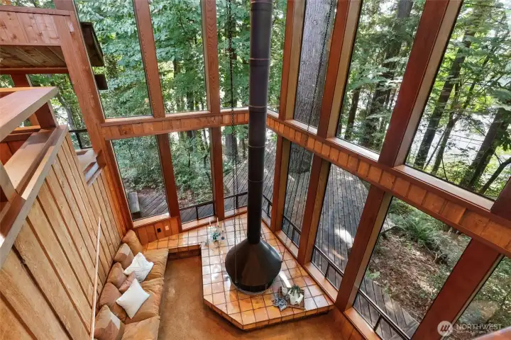 Highest level views of lowest level flanked by massive windows offering lake views