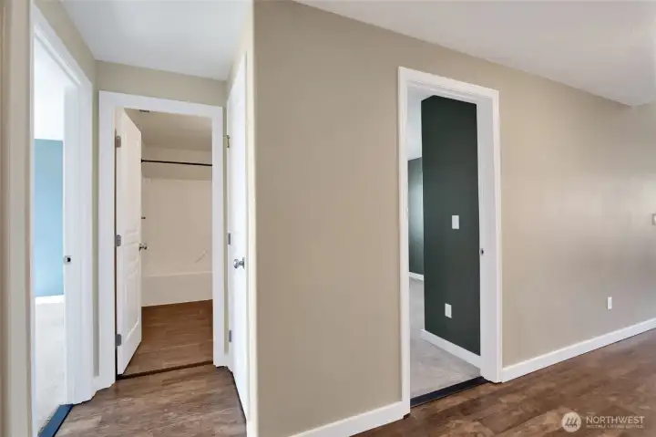 Thoughtful hallway layout provides convenient access to the secondary bedroom and full guest bathroom while maintaining privacy throughout the home.