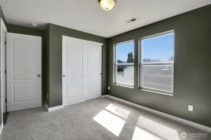 Comfortable secondary bedroom with closet storage.