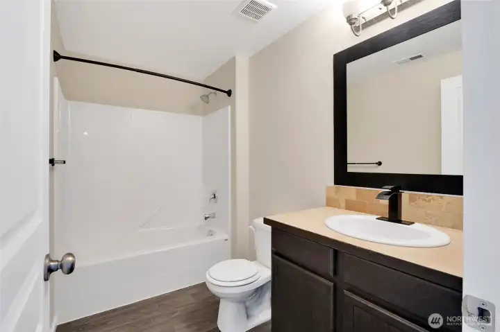 Full guest bathroom conveniently located near the secondary bedrooms.