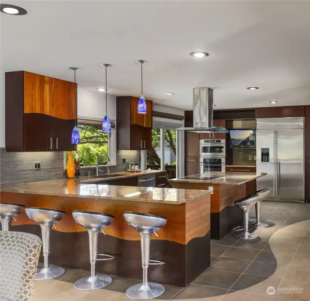 Kitchen with the designer’s custom-built cabinets and granite countertops and high-end appliances.