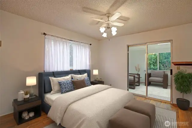 Light & bright primary bedroom has a full wall length closet & slider doors to sunroom!