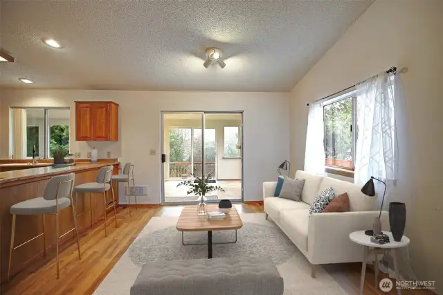 Living room features vaulted ceilings & slider doors out to the extra 360sq ft of living space in sunroom!