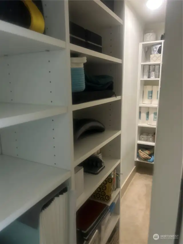 Walk in closet with tons of storage.