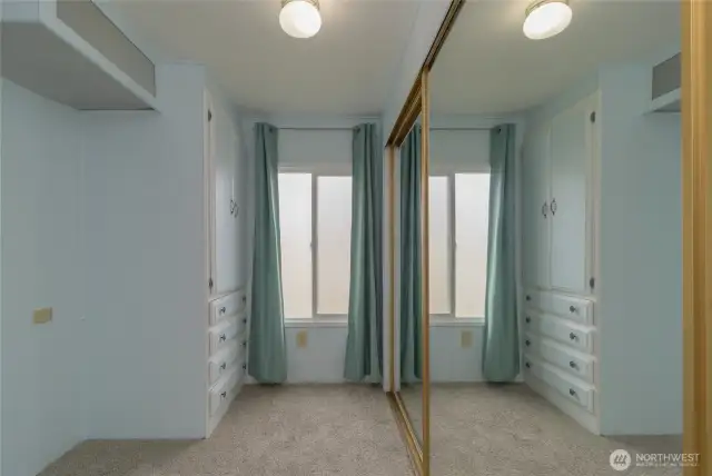 Dressing area with closets and drawers off of the Primary Bedroom