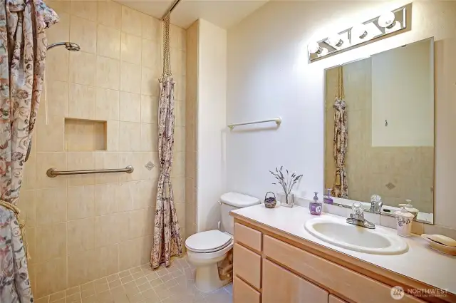 main level bathroom featuring large shower