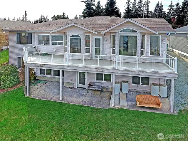 Back of home with upper deck and lower patio to enjoy the amazing views