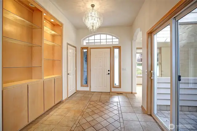 Huge entry featuring display shelving AND outside small patio through slider.