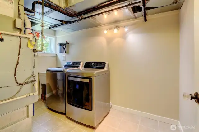 The utility room includes a sink, washer and dryer and houses the water heater and furnace, (both less than 8 years old).