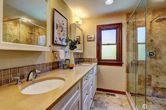The primary bathroom includes a rain shower, double sinks and lots of storage.