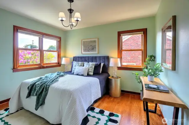 The second bedroom on the main level has natural light from two sides and views to a spacious rear garden.