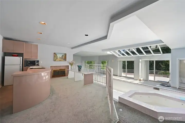 The home essentially has its own private health club. There is a long indoor pool, a large hot tub, a sauna, a full second kitchen and plenty of room for weights, a Peloton as well as most any other athletic equipment you might wish for.