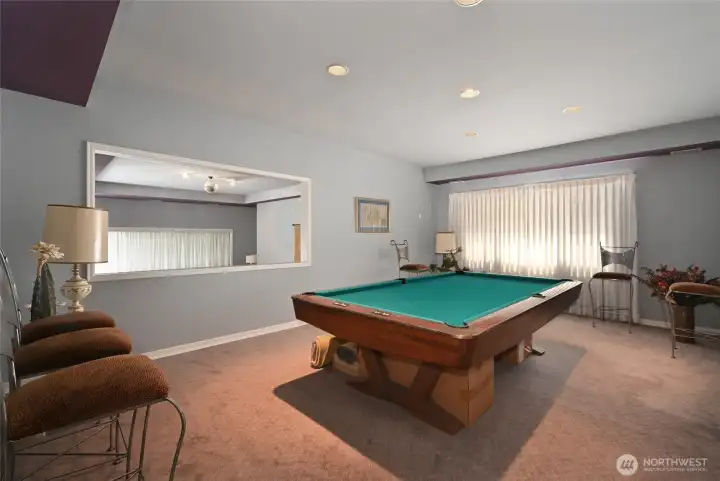 Overlooking the ball room is a billiard room.