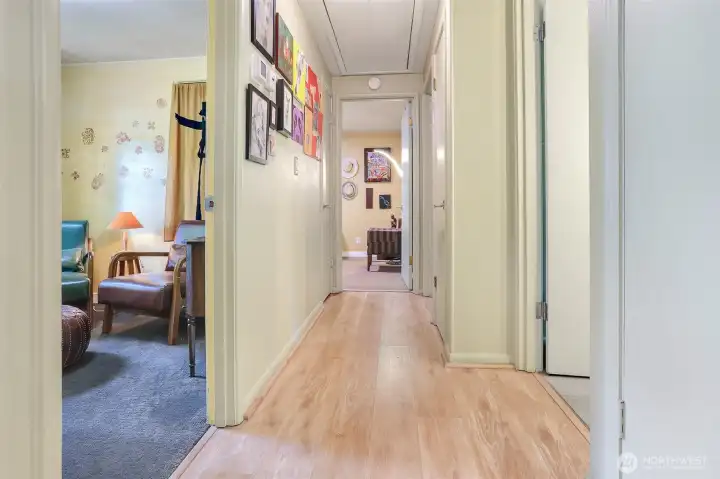 Hallway leading to three bedrooms and the bathroom.