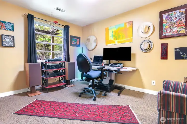 Bedroom #2 is currently being used as a home office. It has a peaceful outlook of the front yard. New carpet was  installed in 2024.
