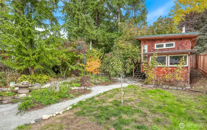 You will love the Northwest styling of the fabulous detached artist studio. Hardy metal roof and shingle clad exterior! Located at the corner of the back yard. It also has a potting shed attached to it.