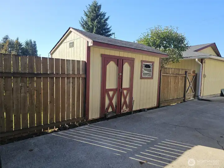 Shed at the end of the driveway. Gate leads to back yard.