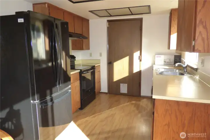 Another view of the kitchen with new frig.
