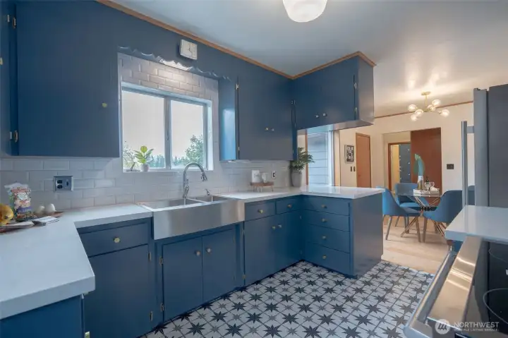 Kitchen boasts porcelain tile floors, quartz counter, new stainless steel appliances and large apron sink! Check out the original restored details!