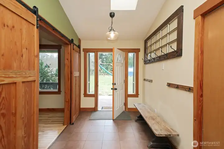 Tiled foyer to hang up coats and take off your shoes.  Barn doors lead to a cozy den.