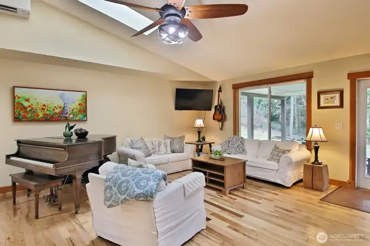 Spacious living area with skylights, big picture windows and French doors to the patio.
