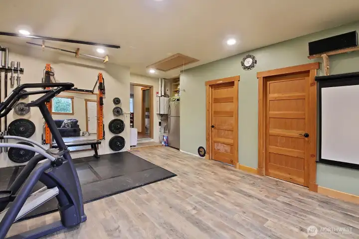 Garage conversion to rec room with two additional rooms.  There is an on demand water heater and additional refrigerator in the nook.  And just through the doorway is a 3/4 bath with laundry.