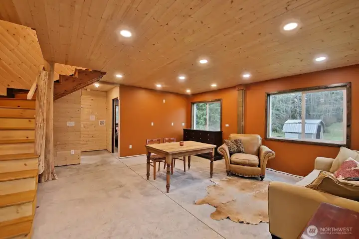 The DADU is plumbed for a kitchen in the corner and laundry on the hall...  Tongue and groove walls and ceilings and Ash wood staircase with tree support.  Concrete floors downstairs.