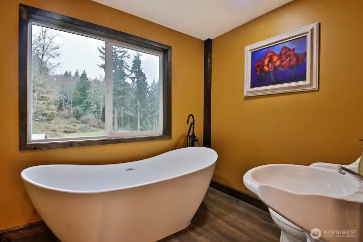 3/4 Bath upstairs in DADU offers soaking tub and pedistal sink.  There are pretty territorial views of the property from upstairs!