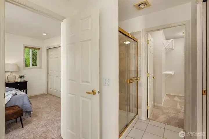 Note the abundant closet storage with one closet within the bedroom and a second walk-in closet through the bath
