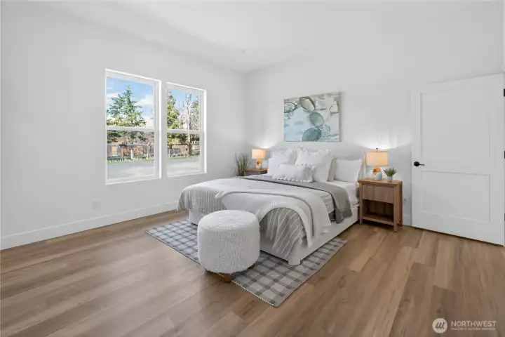 Generous primary suite featuring a walk-in closet and an en-suite bathroom