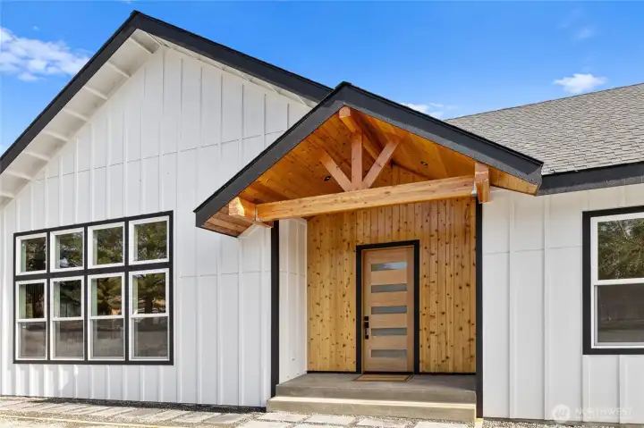 The front exterior features a modern, streamlined blend of materials that creates a polished, contemporary presence