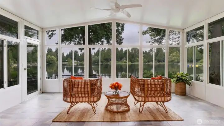 A large additional room (the lake room) with full views of the lake has heated tile floors, ceiling fan, and second door to the backyard.