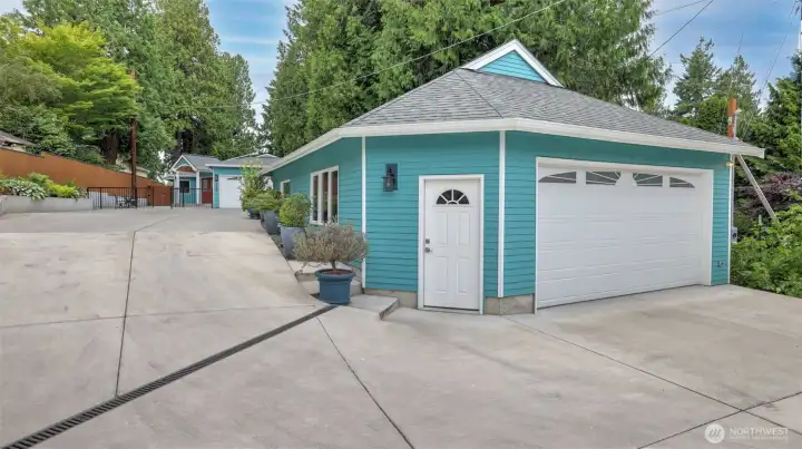 Detached 800 square foot garage has a kitchenette and 3/4 bath, tankless water heater and hot and cold spigots to wash cars. The building has ADU potential.