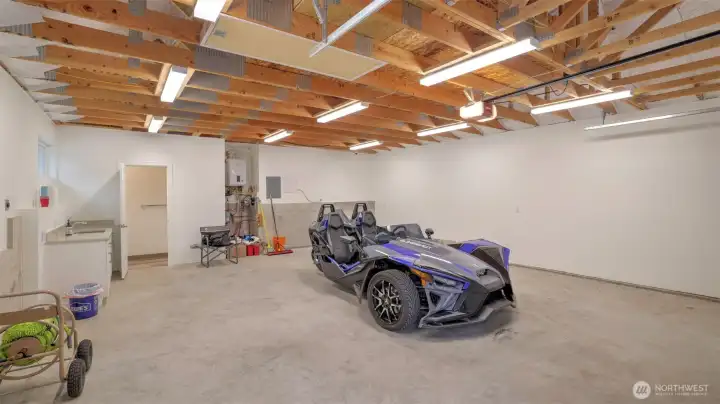 A shot of the detached garage interior. Heated floor, attic space, tankless water heater. A generator is shared between this garage and the main home.
