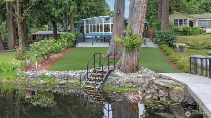 35 ft of low bank waterfront with dock, swim steps and two ladders.