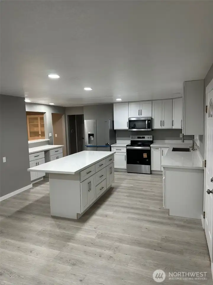 To the left of the kitchen is a pass through bar and nook