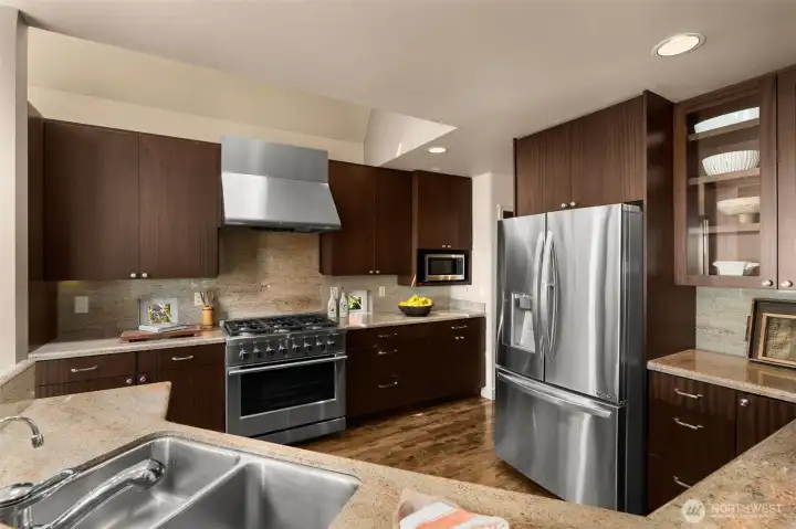 Abundance of solid sapele wood kitchen cabinets. Brand new commercial style gas range
